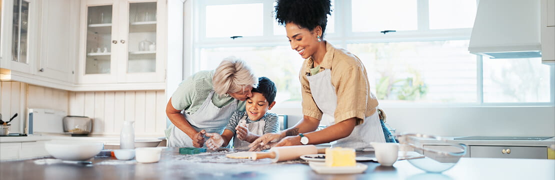 Grandmother, mother, and child in the kitchen baking cookies